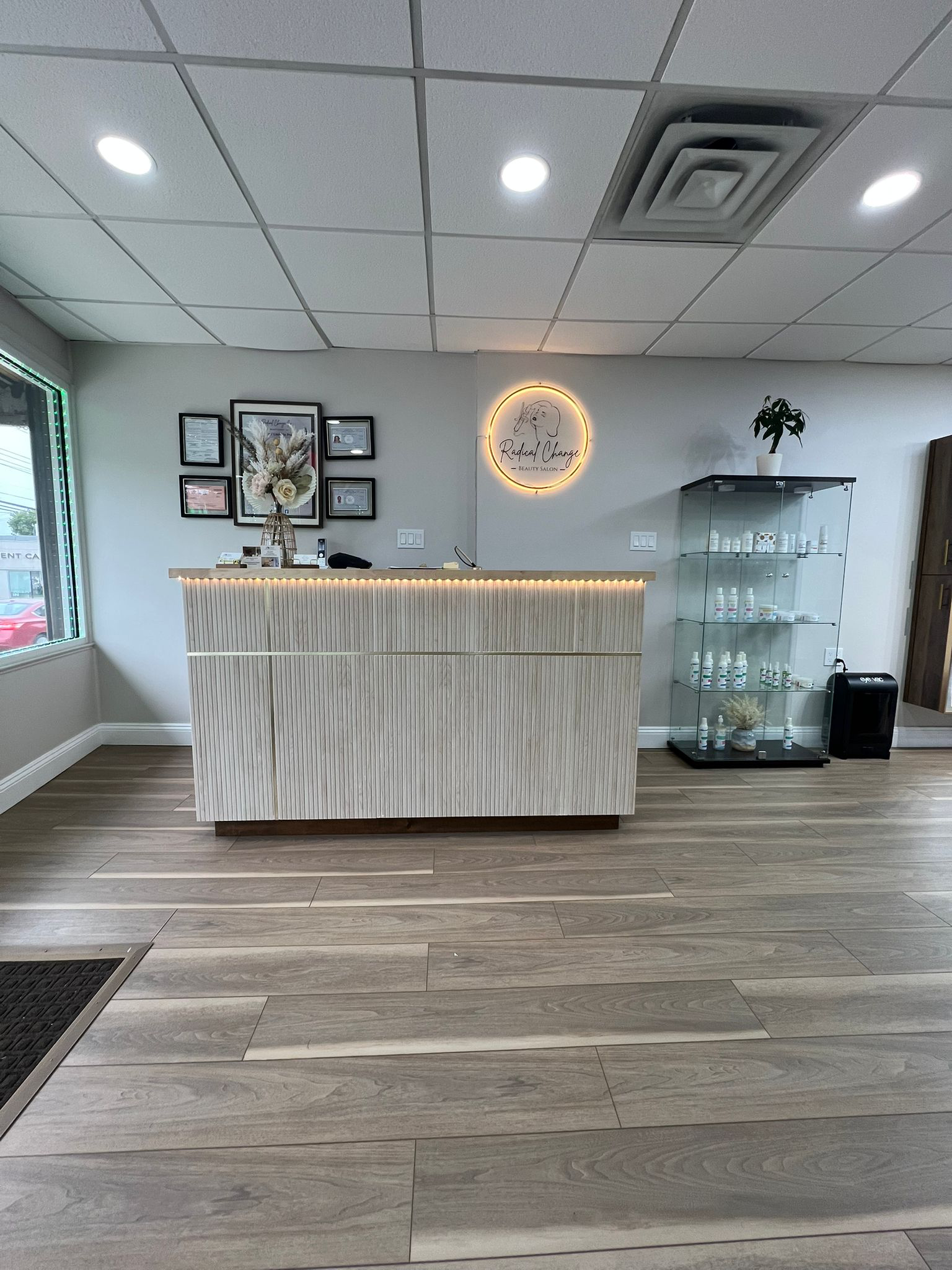 Reception desk with glowing Radical Change round logo sign